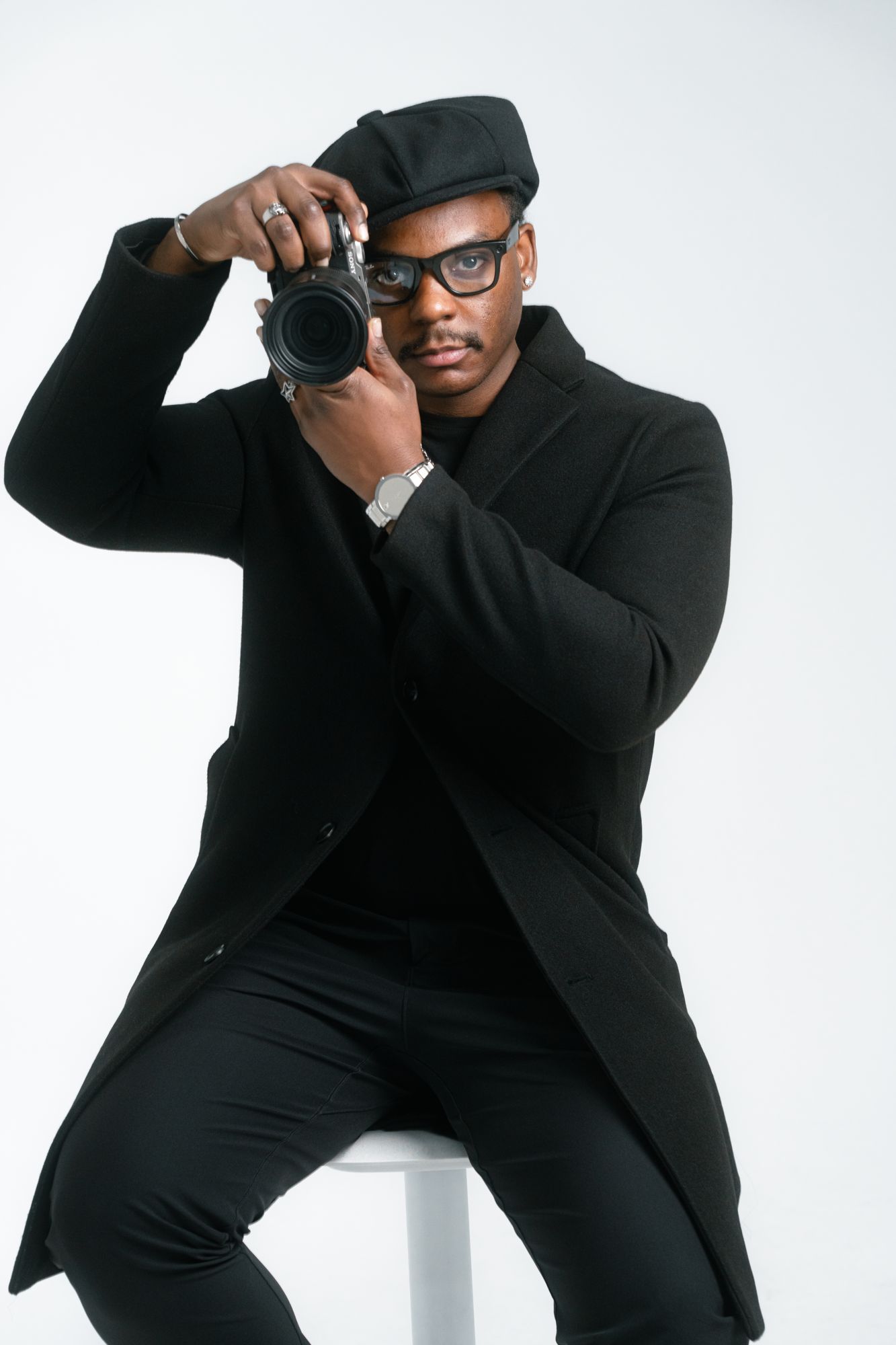 Malik Zambezi in a black coat with his camera